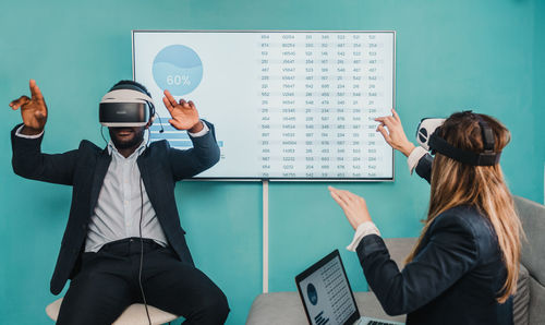 Business people using virtual reality simulator at office