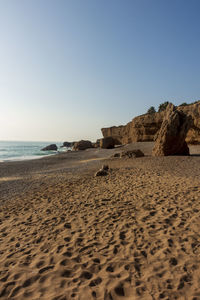 Scenic view of beach against clear sky