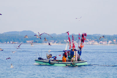 Boat in calm lake against clear sky