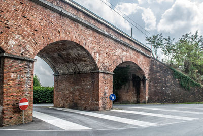 Red brick bridge against cloudy sky  in tuscany, italy. 