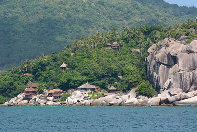 Panoramic view of sea and buildings against mountain