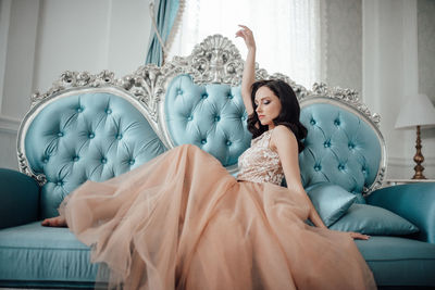 Woman sitting on sofa at home