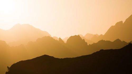 Scenic view of mountains against clear sky during sunset