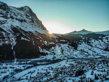 Scenic view of snowcapped mountains against sky during sunset