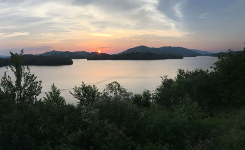 Scenic view of lake against sky during sunset