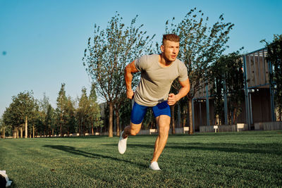 Portrait of young man playing soccer on field