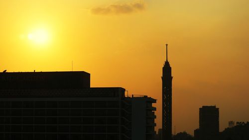Silhouette of buildings against sky during sunset