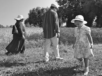 Rear view of girl standing on field