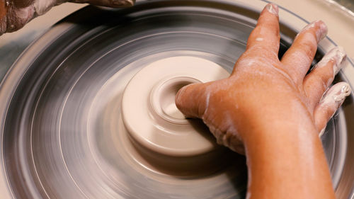 Cropped hand of man working at workshop