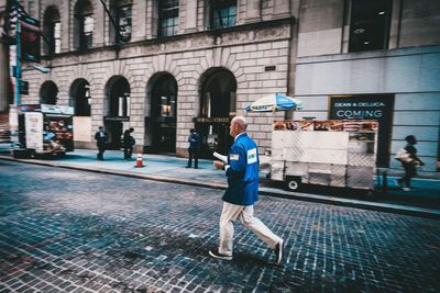 Full length of man walking in city