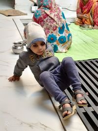 Portrait of boy sitting on floor