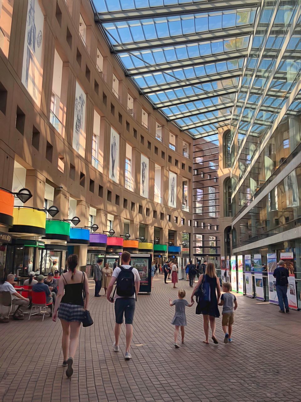 GROUP OF PEOPLE WALKING IN MODERN BUILDING