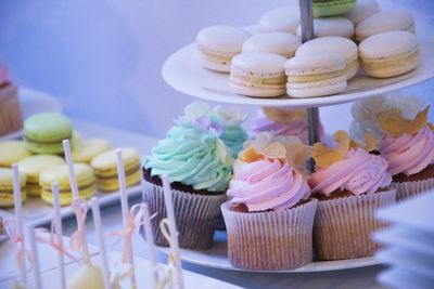 Close-up of cupcakes and macaroons in stand