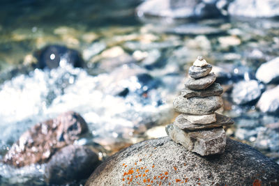 Stone pyramid cairn near river, buddhism tradition, zen, harmony