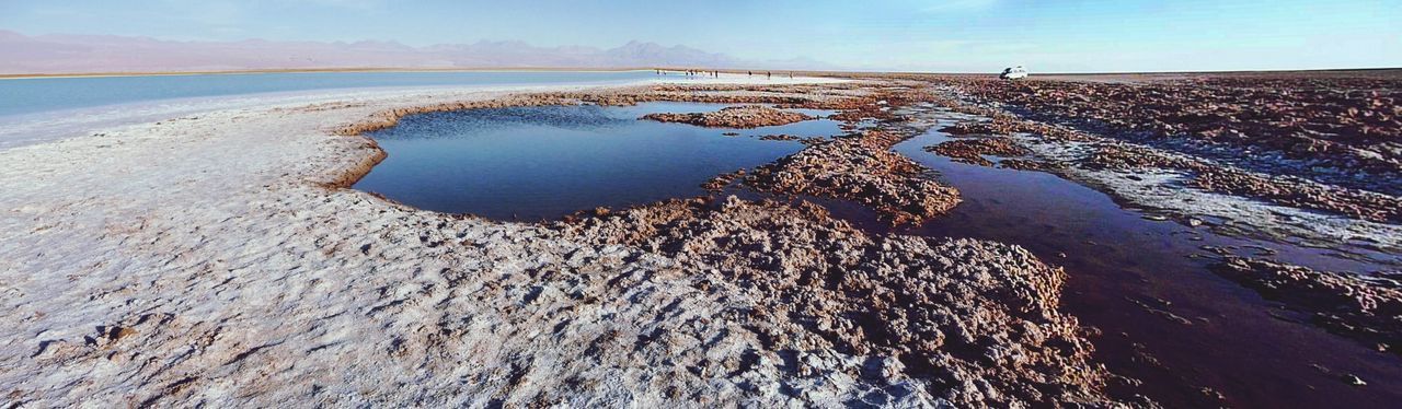 tranquility, tranquil scene, scenics, sky, nature, beach, beauty in nature, water, blue, sea, snow, day, winter, landscape, rock formation, outdoors, cold temperature, no people, idyllic, sand