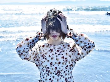 Full length of woman standing at beach