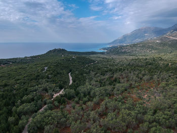 Scenic view of landscape and sea against sky