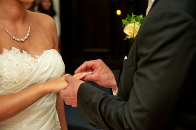 Midsection of couple during ring ceremony