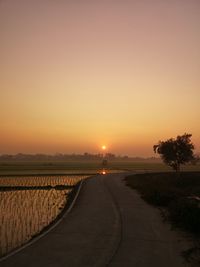 Scenic view of road against sky during sunset