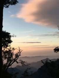 Scenic view of silhouette mountains against sky at sunset