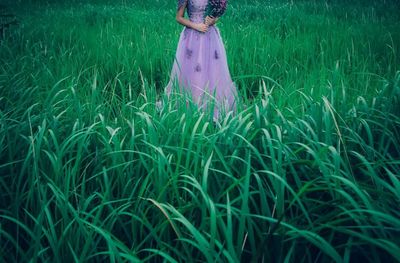 Woman standing on grassy field