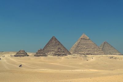 Scenic view of desert against clear blue sky pyramid 