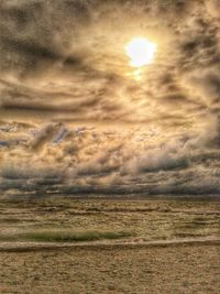 Scenic view of field against cloudy sky