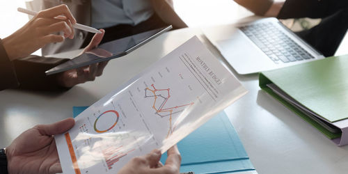 High angle view of mobile phone and book on table