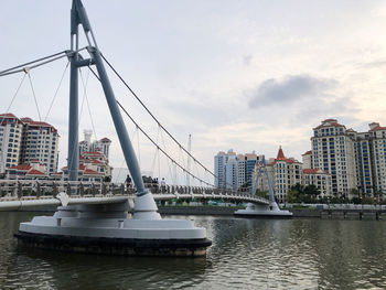 Sailboats in city against sky