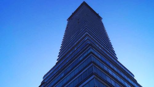 Low angle view of building against clear blue sky