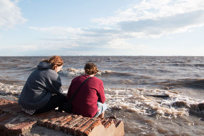 Romantic couple sitting by the sea