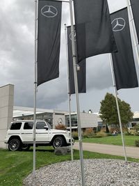 Cars on road against sky in city