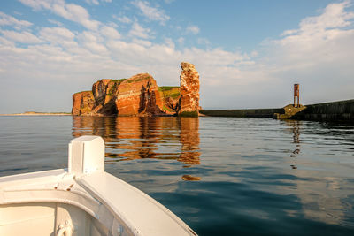 Scenic view of rock formation in sea against sky