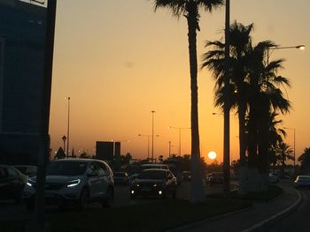 Traffic on road at sunset