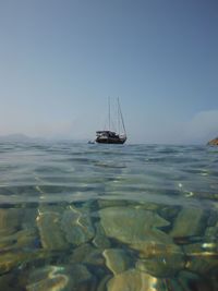 Ship in sea against clear sky