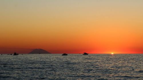 Scenic view of sea against orange sky during sunset