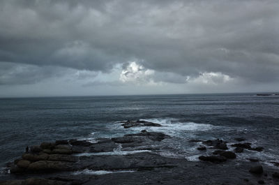 Scenic view of sea against storm clouds