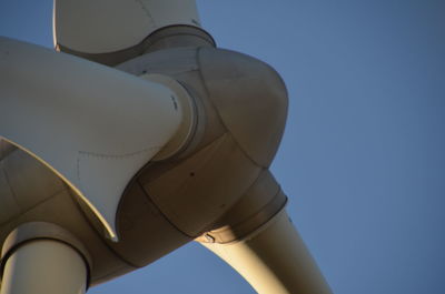 Low angle view of airplane against clear blue sky