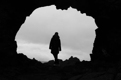 Full length of woman standing in cave