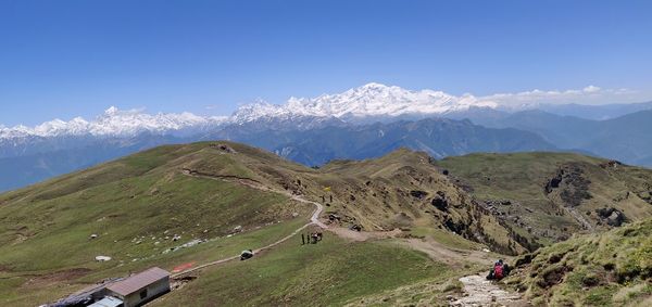 Scenic view of mountains against blue sky