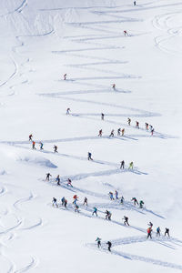 High angle view of people skiing in snow