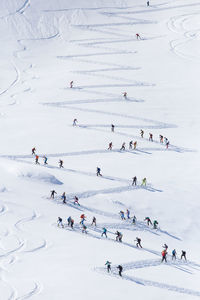 Group of people skiing on snowcapped mountain