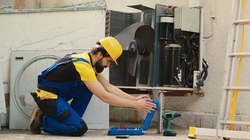 Rear view of man working at construction site