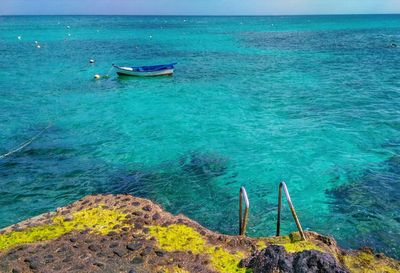 Boat in sea against blue sky