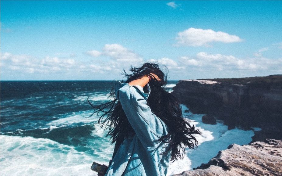 one person, sea, sky, water, long hair, young adult, leisure activity, hair, real people, lifestyles, hairstyle, nature, standing, land, scenics - nature, beauty in nature, waist up, young women, horizon over water, outdoors