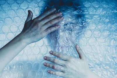 Low section of woman with people in swimming pool