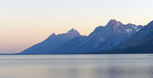 Twilight on the grand tetons on jackson lake in wyoming