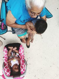 High angle view of father and daughter sitting on floor