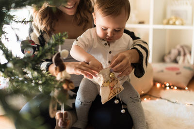 Mother and daughter on christmas tree