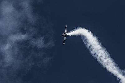 Low angle view of airplane flying in sky